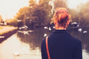 Rear view of young woman watching birds